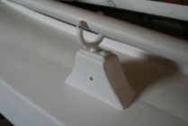 6 - Pinned oarlocks keep icy oars from escaping. The scupper in the stanchion keeps rain from freezing in the sockets.