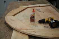 Softwood is glued and screwed to top and bottom of plywood to take fasteners and allow for beveling.